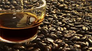 coffee cup and coffee beans Clear coffee cup on a pile of coffee beans